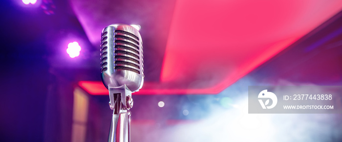 Close-up old retro vintage microphone on blurred stand up smoke background concert banner