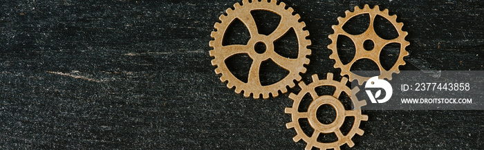 top view of vintage metal gears on dark wooden background with copy space, panoramic shot