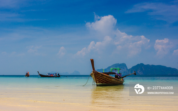 Traditional thai longtail boats on the beach of Ko Ngai, Koh Lanta, Thailand.