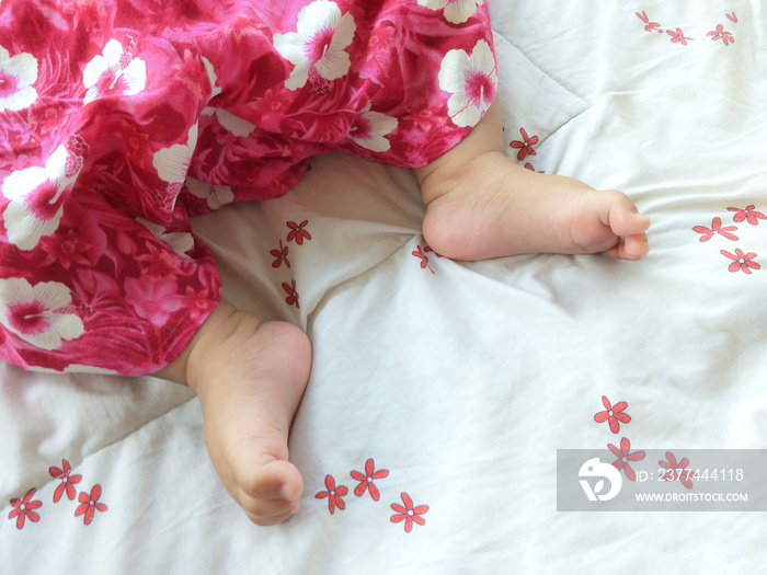 Top view of sleeping female baby feet on sleeping bag, softly focus for interesting image