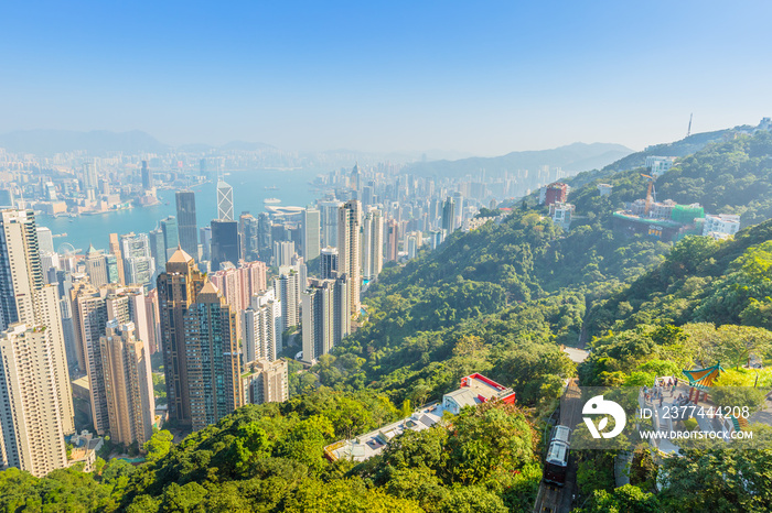 Aerial view of popular Peak Tram, Lion’s Pavilion terrace and Hong Kong cityscape from Victoria Peak, the highest peak of Hong Kong island.