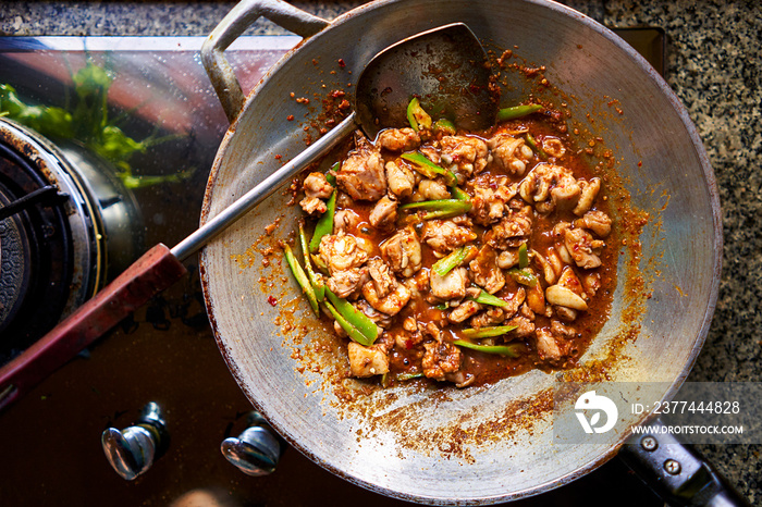 freshly cooked red thai curry in wok with chicken