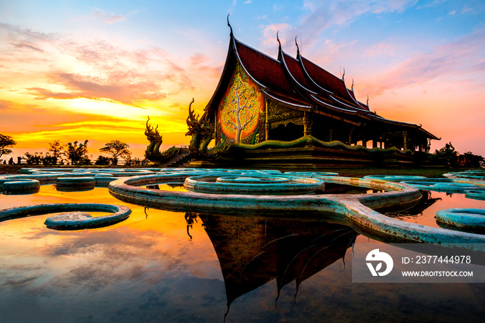 Amazing Temple Sirindhorn Wararam Phuproud in Ubon Ratchathani Province at twilight time,Thailand.Thai temple with grain and select white balance.Night sky effect for Long exposure photo taken.