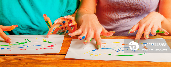 Art therapie and creativity concept. Close up young women painting with finger.