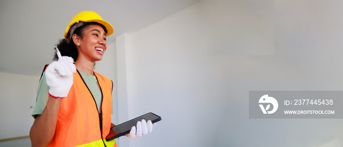 portrait happy smling black woman. Professional black femal engineers and inspectors investigating the neatness of houses under construction in housing projects.