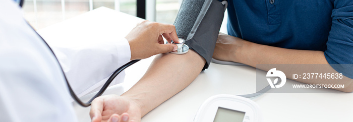 Female doctors use blood pressure monitors and stethoscope to measure pulse Diagnose the patient’s disease in a modern hospital medical laboratory, Medical treatment and health care concept.