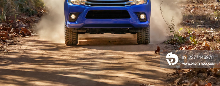 4x4 SUV car driving on a dusty dirt road