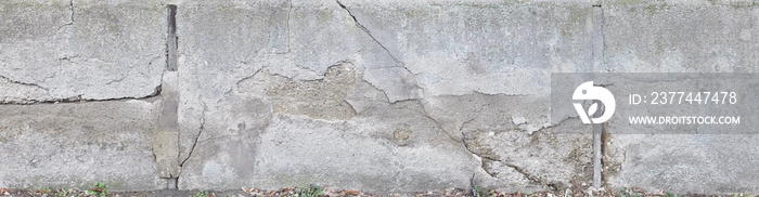 Old crumbling concrete wall in panoramic format.