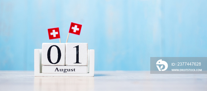 Wooden calendar of August 1st with miniature Switzerland flags. Swiss National Day and happy celebration concepts