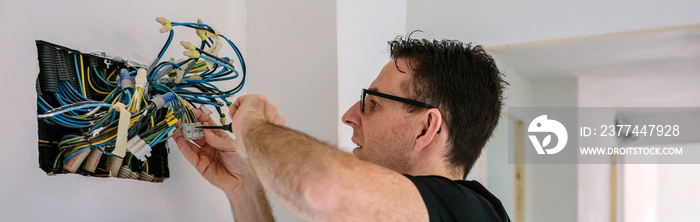 Electrician working on the electrical installation of a house