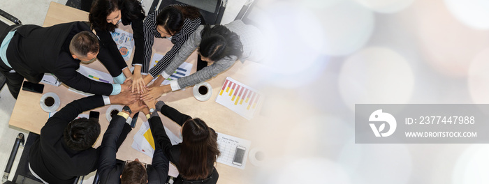 Happy business people celebrate teamwork success together with joy at office table shot from top view . Young businessman and businesswoman workers express cheerful victory in broaden view .