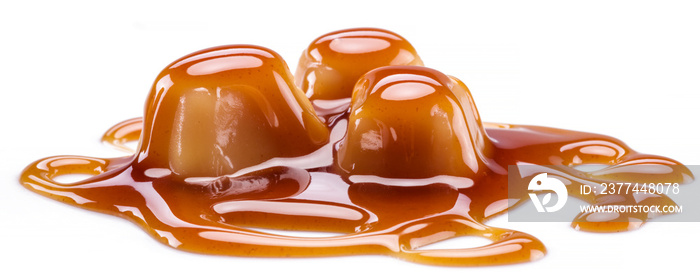 Caramel candies covered with melted sugar caramel isolated on white background.