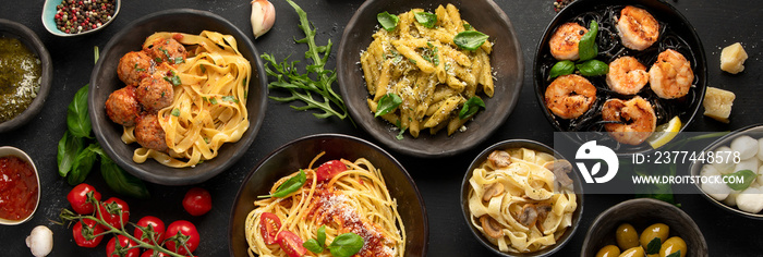 Assortment of Italian pasta with traditional sauces for dinner on dark background.