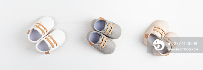 Gender neutral baby shoes. Banner. Baby shower invitation, greeting card