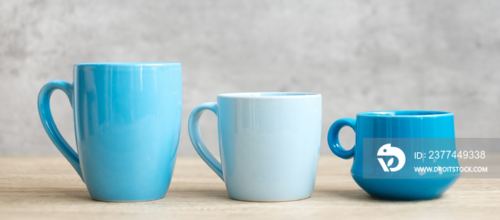 Blue coffee cup and tea mug on wood table background in the morning, Blank copy space for text. International coffee day and daily routine concept