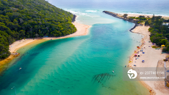 Aerial view over Tallebudgera creek Gold Coast, with swimmers on the beach