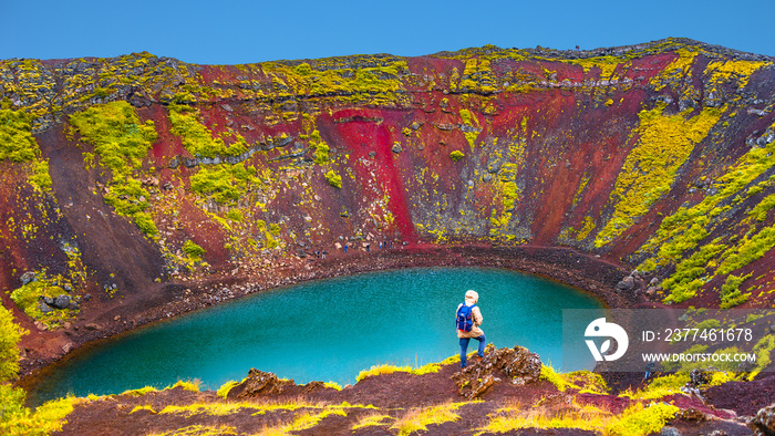 Famous colorful and dangerous Kerid volcanic crater with lake inside on Iceland during sunset, summer time