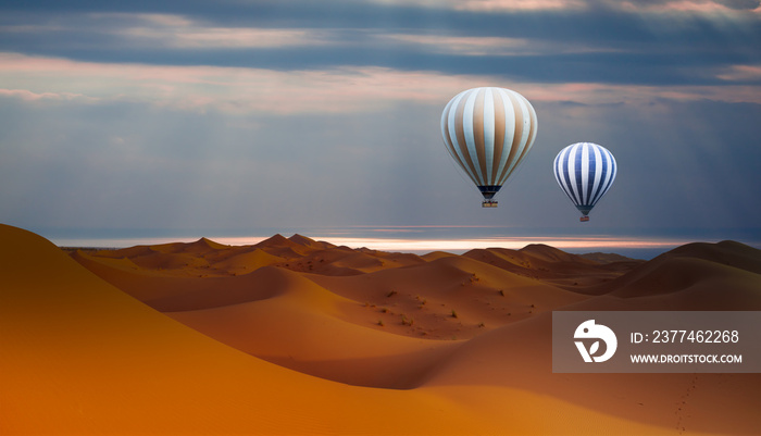 Hot air balloon flying over sand dunes in the Sahara Desert - Orange dunes in the desert of Morocco Atlantic ocean in the background - Sahara desert, Morocco