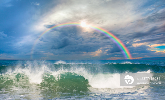 Rainbow over the stormy sea after rain