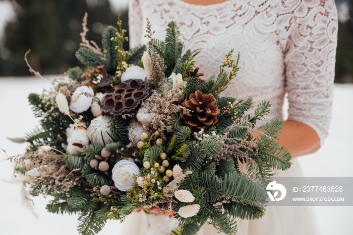 Winter wedding bouquet. Bride   holds a wedding winter bouquet. Winter  wedding style..