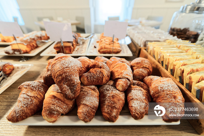 Sweet french croissants pastry with jam and cream