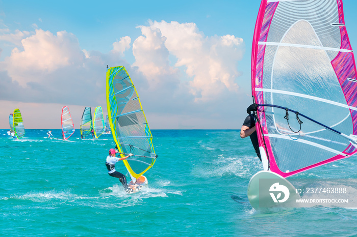 Beautiful cloudy sky with windsurfer surfing the wind on waves in Alacati - Cesme, Turkey