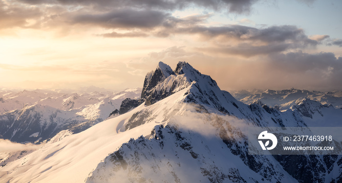 Aerial View from Airplane of Blue Snow Covered Canadian Mountain Landscape in Winter. Colorful Pink Sunset Sky Art Render. Tantalus Range near Squamish, North of Vancouver, British Columbia, Canada.