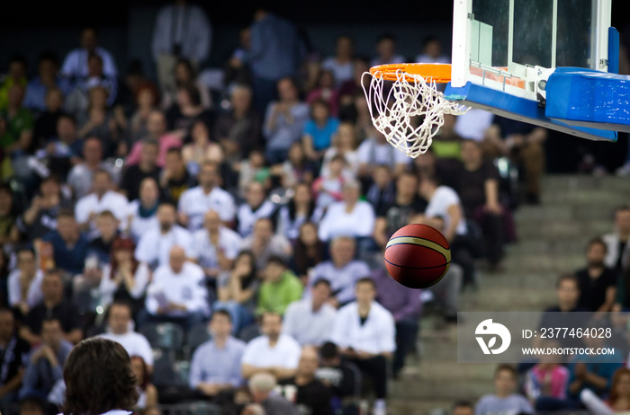 Basketball going through the hoop at a sports arena