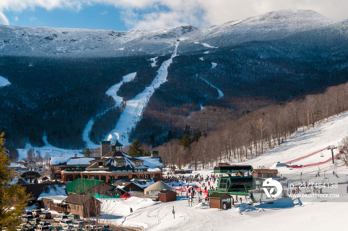 Spruce Peak Lodge in the winter with Mt. Mansfield in the background, Stowe, Vermont, USA