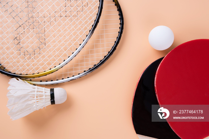 Table tennis and badminton on yellow background. Top view