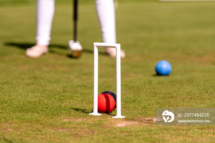 female croquet player hitting the ball with mallet