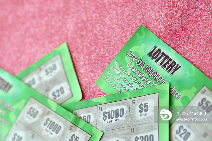 Close up view of green lottery scratch cards. Many used fake instant lottery tickets with gambling results. Gambling addiction