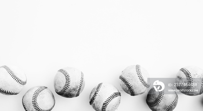 Isolated baseball balls close up on white background, horizontal sports banner in black and white.