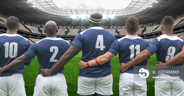 Composition of male rugby team embracing at stadium