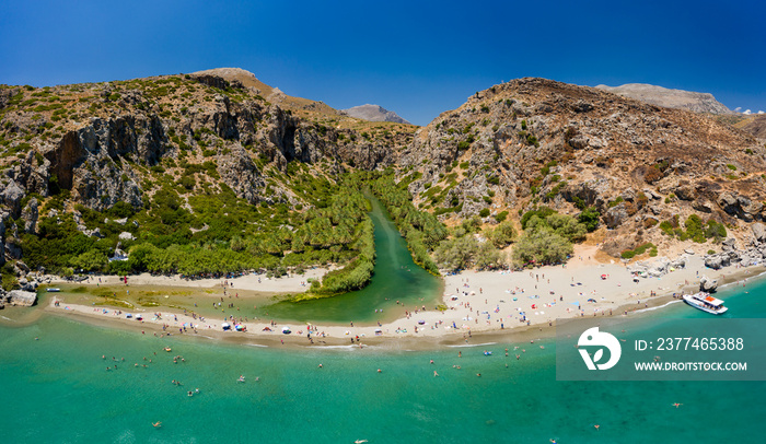 Aerial view of a beautiful sandy beach and palm tree lined gorge (Preveli, Crete)