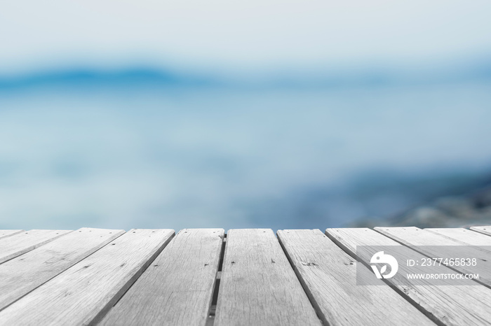 Selective focus of old wood table with beautiful beach background for display your product.