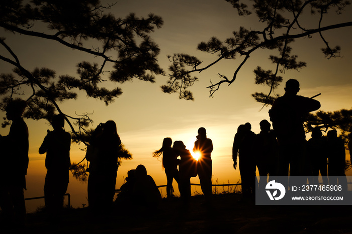 Silhouette of tourists watching the sun at dawn  , Phu Kradueng National Park ,Thailand