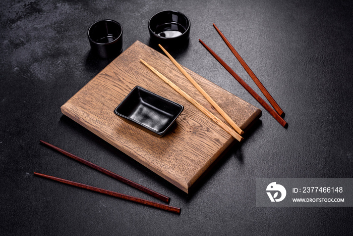 Wooden sushi sticks on a dark concrete background