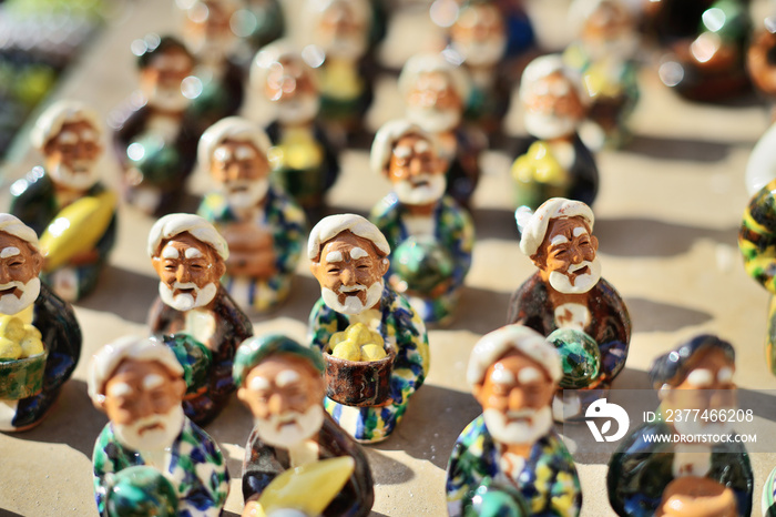 Ceramic statuettes of Uzbek men dressing in traditional costume, Itchan Kala (Xiva Ichon Qala) UNESCO world heritage, Khiva, Uzbekistan.