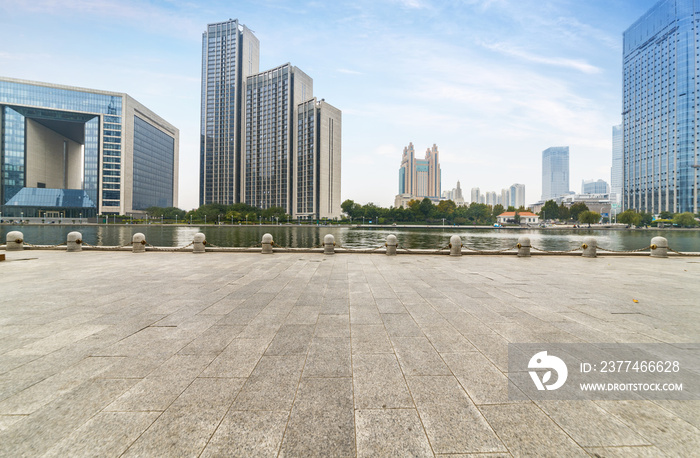 empty tiled floor and urban skyline,tianjin china