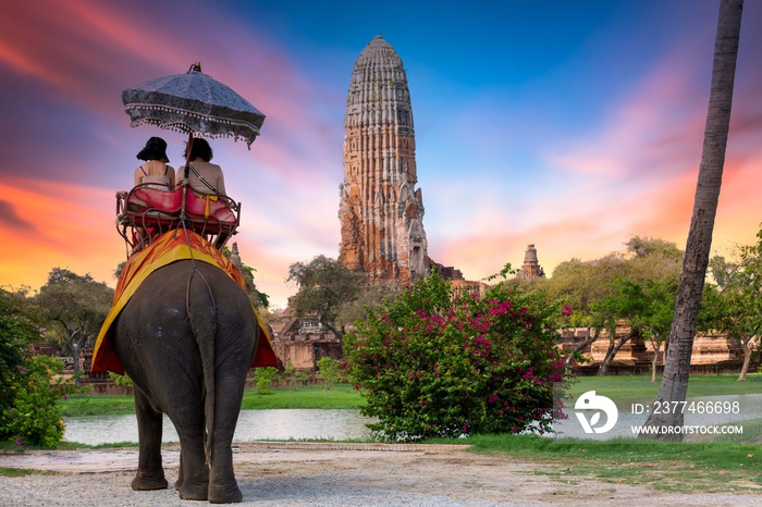 The Elephant for tourist service at Ayutthaya Archeology, Tourists riding elephant  in ancient history architecture in Ayutthaya Historical Park, Ayutthaya ,Thailand.