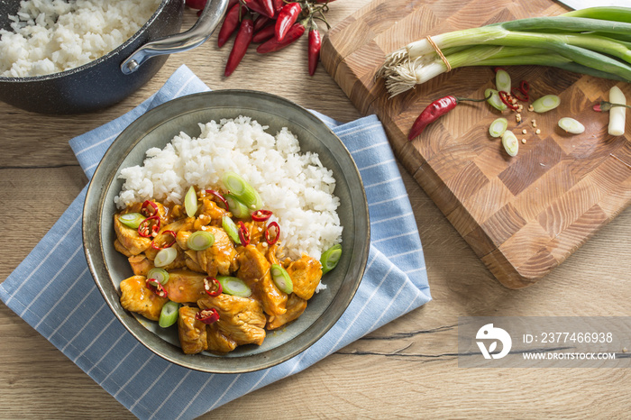 Chicken curry rice chili and young onion in bowl