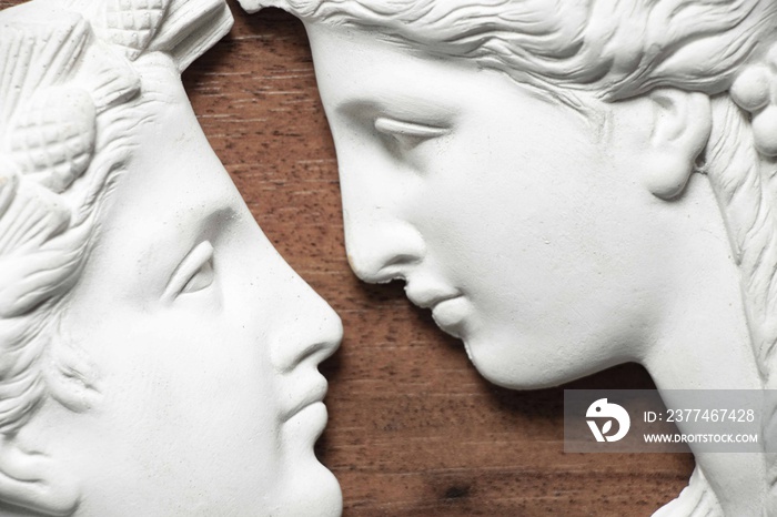 sculpture of two faces looking at each other made of plaster