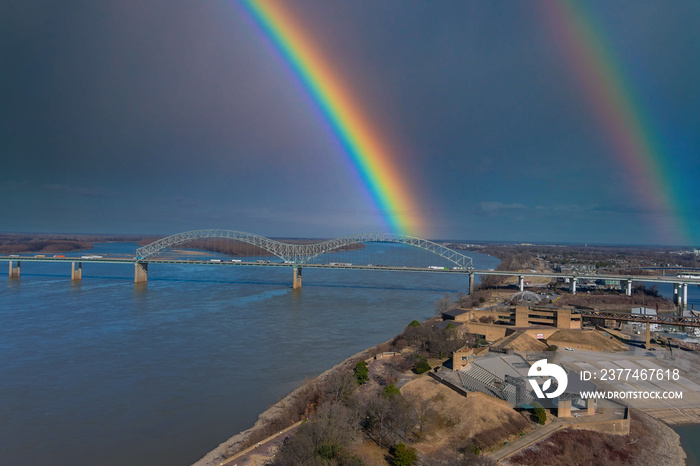 Hernando de Soto Bridge over the river with blue sky and a rainbow in the clouds in the sky at Mud Island Park in Memphis Tennessee USA
