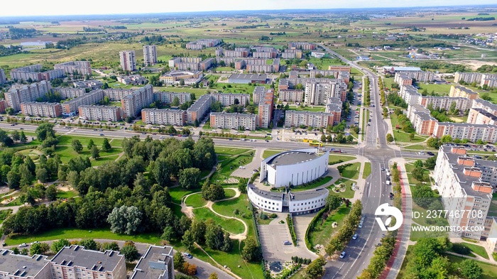 Aerial panoramic view of the southern part of Siauliai city in Lithuania.Old soviet union buildings with green nature around, park and modern church