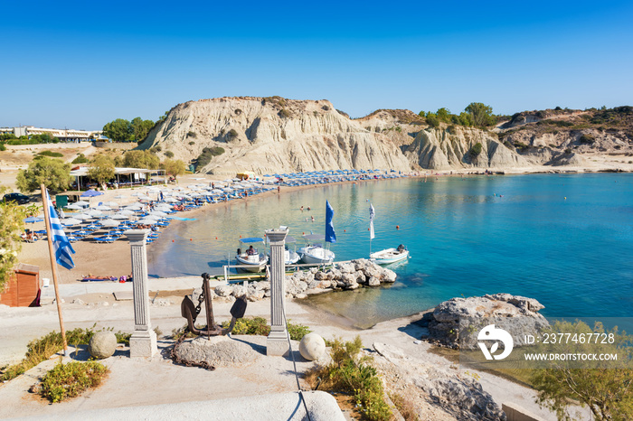 Kolymbia beach with umbrellas, sunbeds and boats (Rhodes, Greece)