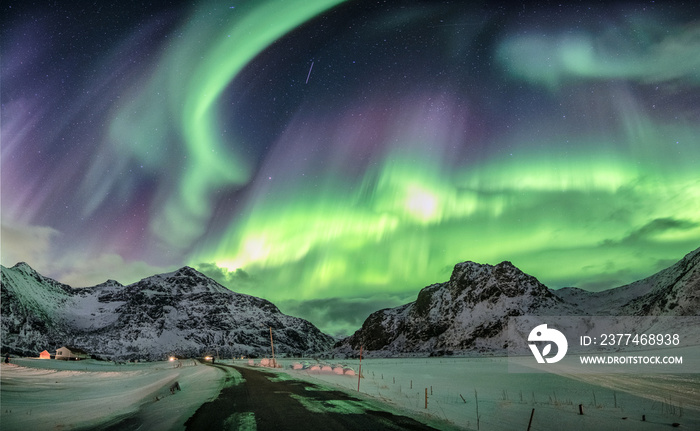 Aurora borealis, Northern lights over snow mountain range