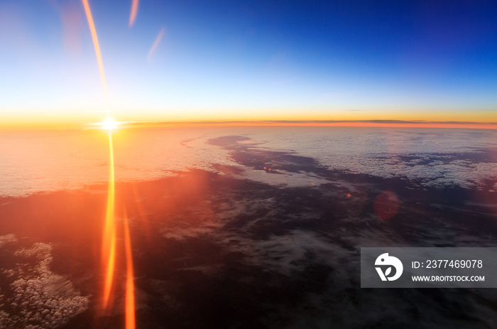 Beautiful aerial sunrise cloudscape with a blue morning sky and bright summer sun in the Netherlands