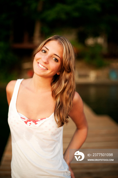 Portrait of woman smiling on lake jetty