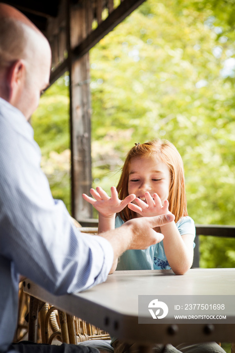 Father playing with his daughter on balcony